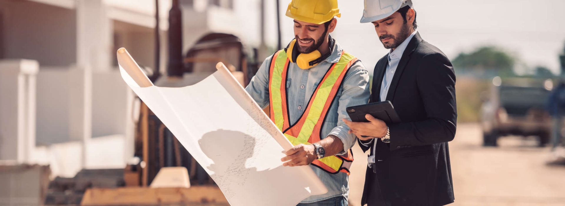 civil-engineer-construction-worker-manager-holding-digital-tablet-blueprints-talking-planing-about-construction-site-cooperation-teamwork-concept_low